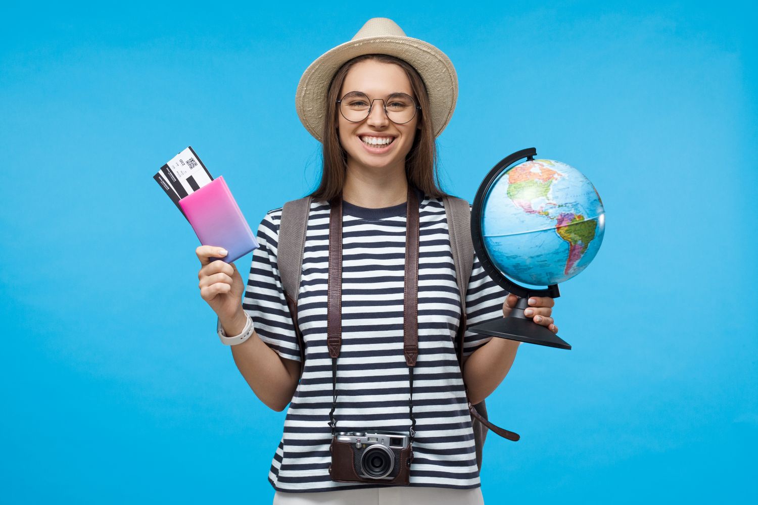 girl holding globe and passport